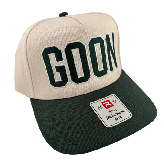 Beige and green cap with 'GOON' text on a light gray background